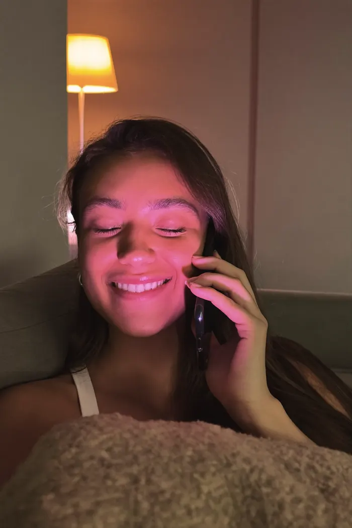 Person chatting with an AI companion on their phone in the evening