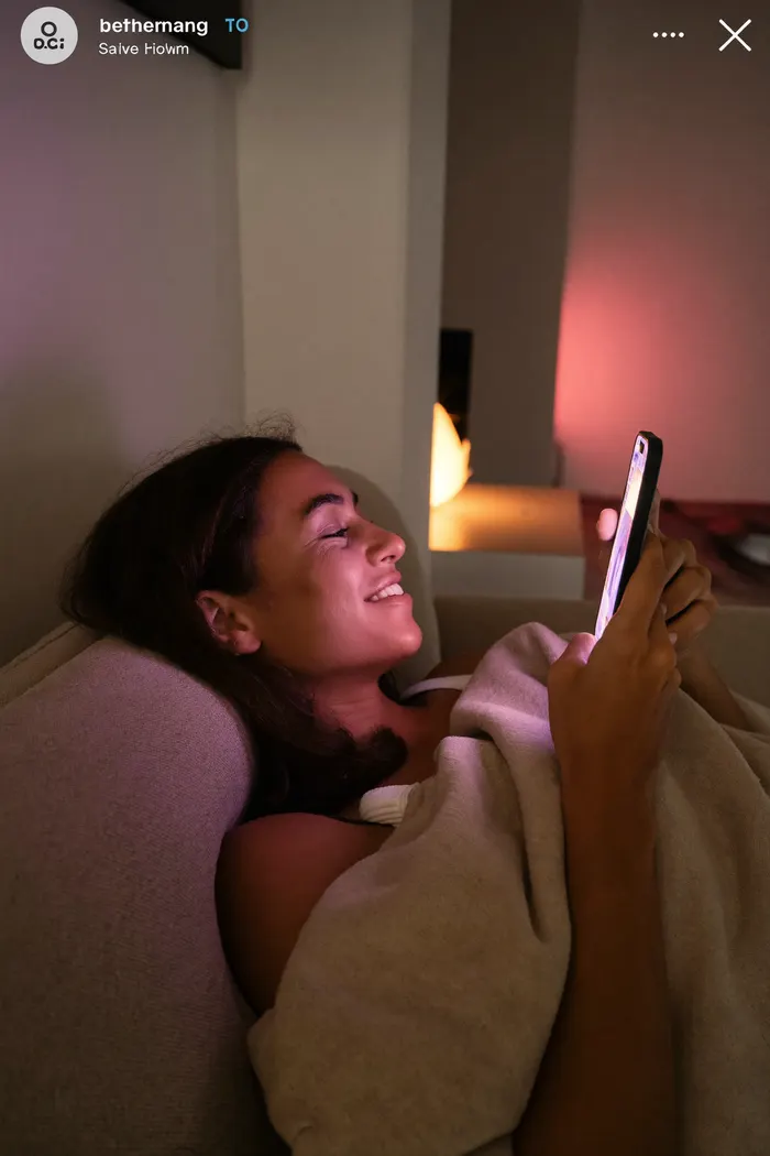 Person enjoying a late-night chat with an AI companion on their phone